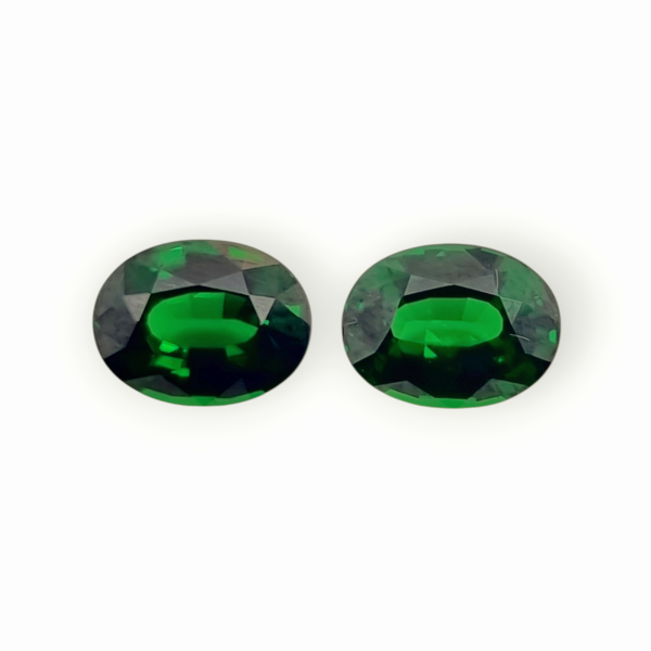 Matching pair of 4.53-carat Tsavorite gemstones in vivid green, oval cut with superior clarity and brilliance, perfect for jewelry making.