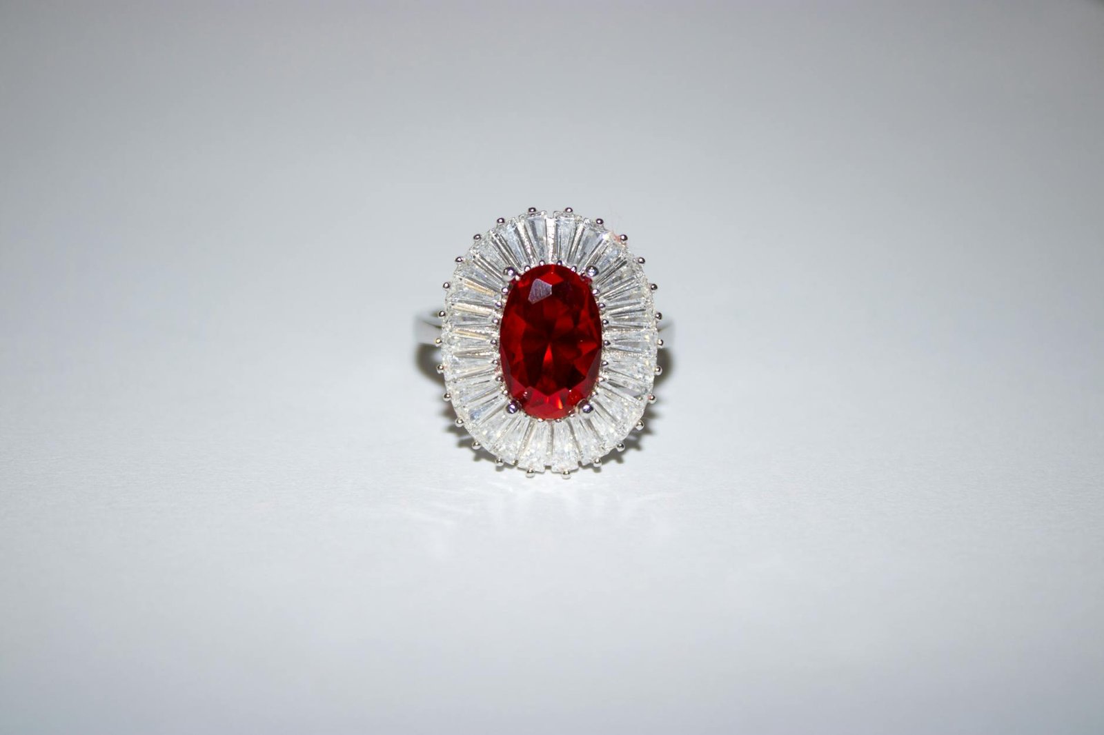 A stunning ruby and diamond silver ring elegantly displayed against a light background.