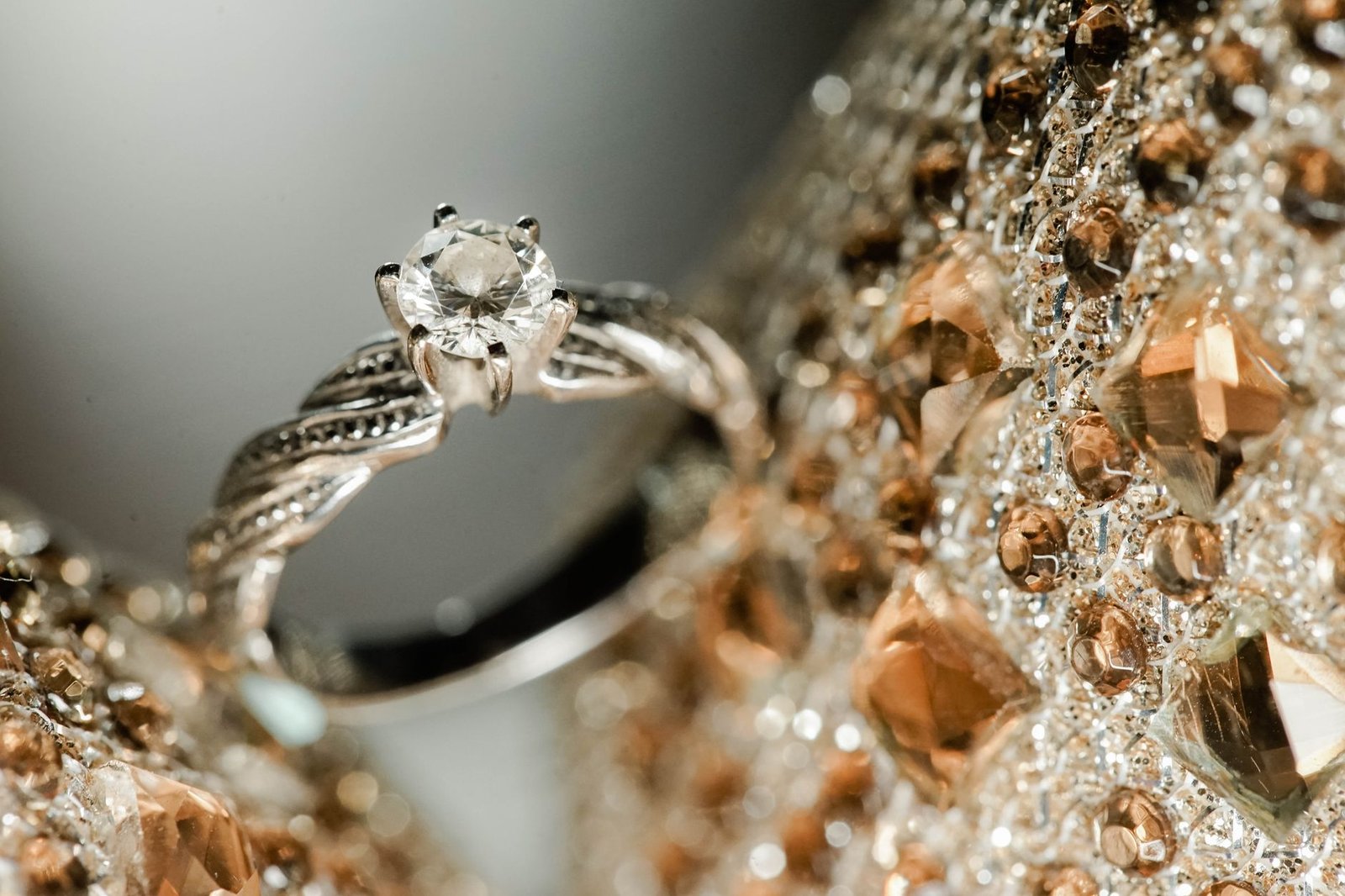 Close-up of a diamond engagement ring with intricate design and luxury backdrop.